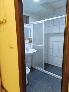 a bathroom with a shower and a toilet and a sink at 路邊望海 in Jiufen