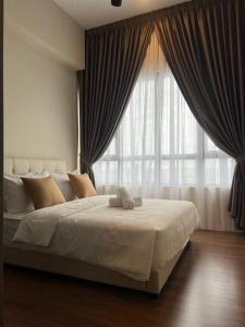 a bedroom with a large bed with a large window at Millerz Suite 3R2B Condo Near MidValley 3 Beds 3 Bedrooms Staycation Best Choice in Kuala Lumpur