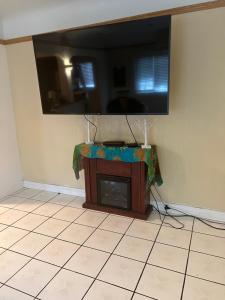 a tv on the corner of a room with a fireplace at Lucky House in Long Beach