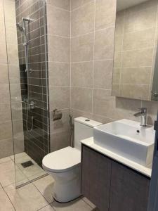 a bathroom with a toilet and a sink and a shower at Millerz Suite 3R2B Condo Near MidValley 3 Beds 3 Bedrooms Staycation Best Choice in Kuala Lumpur