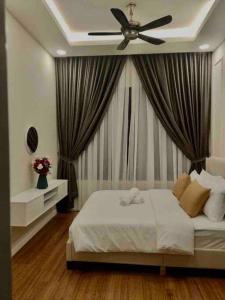 a bedroom with a bed with a ceiling fan at Millerz Suite 3R2B Condo Near MidValley 3 Beds 3 Bedrooms Staycation Best Choice in Kuala Lumpur