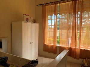 a room with a window and a white cabinet at Cheerful 3-bedroom home indoor & outdoor fireplace in Johannesburg