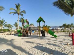 a playground on the beach with palm trees at Star Hawana Salalah Forest Island in Salalah