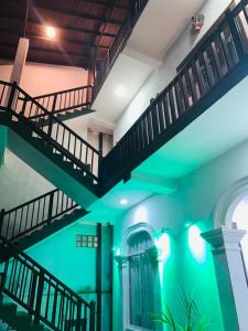 a staircase in a building with green lighting at Hiru Resort Inn Unawatuna in Unawatuna
