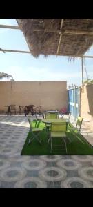 a group of tables and chairs in a patio at Beyout Guest Houses in Ma‘mad