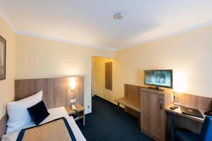 Ein Bett oder Betten in einem Zimmer der Unterkunft Askania Hotel & Brauhaus