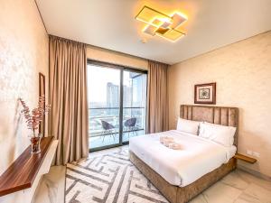 a hotel room with a bed and a large window at STAY Sensational 3BR Holiday Home near BurjKhalifa in Dubai
