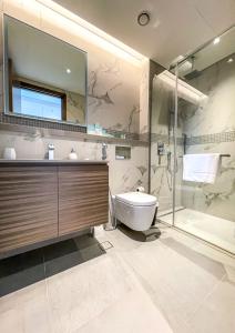 a bathroom with a shower and a sink and a toilet at STAY Sensational 3BR Holiday Home near BurjKhalifa in Dubai