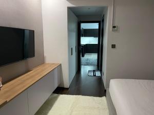 a bedroom with a flat screen tv and a bed at Aeon Tower 2627 in Davao City