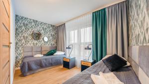 Posteľ alebo postele v izbe v ubytovaní Apartament z 2 sypialniami Elegant Lux 18 E Perłowa Przystań - Holiday City