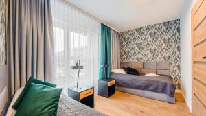 Posteľ alebo postele v izbe v ubytovaní Apartament z 2 sypialniami Elegant Lux 18 E Perłowa Przystań - Holiday City