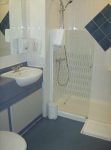 a bathroom with a sink, toilet and shower stall at Diamond Lodge in Manchester
