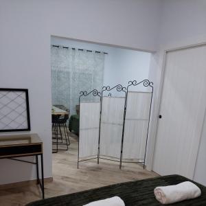 a bedroom with white walls and a bed with a mirror at Avocado Suite by Alhaurín Loft City Center in Alhaurín de la Torre