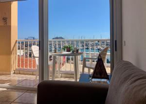 a living room with a view of a balcony with a table at La Bocayna Vistas 3 Islas in Corralejo