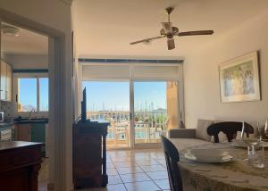 a living room with a table and a ceiling fan at La Bocayna Vistas 3 Islas in Corralejo