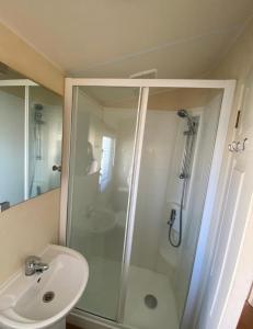 a bathroom with a shower and a sink at Park Home at Lyons Winkups Holiday Park N.Wales in Kinmel Bay +31 photos