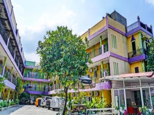 a group of buildings on a street with a tree at OYO 91796 Guest House Ghalta Syariah in Karawang