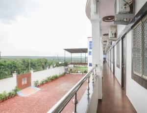 a balcony of a building with a view of a courtyard at Hotel Gopal, Khargone in Khargon