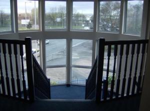 a view of a room with a staircase with windows at Diamond Lodge in Manchester