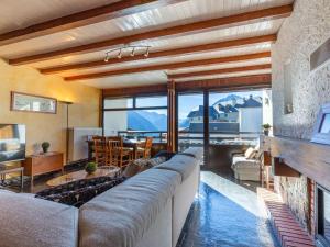 a living room with a large couch and a table at Appartement spacieux 7 pers proche pistes ski Pla d'Adet - FR-1-296-296 in Saint-Lary-Soulan