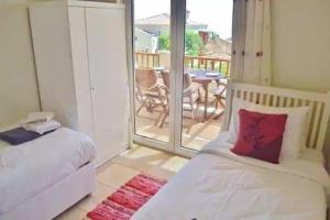 a bedroom with a bed and a balcony with a table at Belvedere, LaVanta, Kalkan in Kalkan