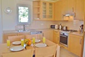 a kitchen with a table with two chairs and a table sidx sidx sidx at Belvedere, LaVanta, Kalkan in Kalkan