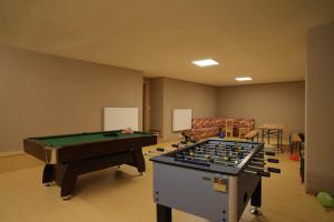 a living room with a pool table and a room with at Ciasa Mirio' in La Valle