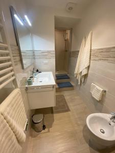 a bathroom with a sink and a toilet and a shower at CANALE SUITE panoramic view - private parking - Natural Park in Sinalunga