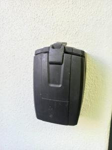 a black electrical outlet on the side of a wall at Lucano 1 Stellenbosch in Stellenbosch