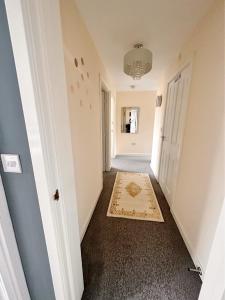 a hallway with a door and a rug at Luxury 2bed Apartment in Wolverhampton in Wolverhampton
