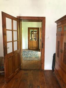 an open door to a room with wooden floors at Feked Farmstay in Feked