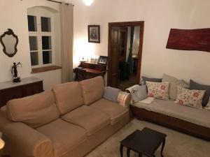 a living room with a couch and a table at Feked Farmstay in Feked +52 photos