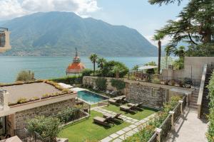 an image of a house with a view of the water at MUSA Lago di Como in Sala Comacina