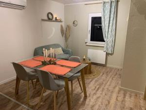 a dining room with a table and a couch at La petite halte in Lemberg