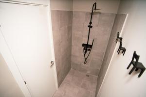 a bathroom with a shower with black fixtures at Sierra Nevada Hostel in Sierra Nevada