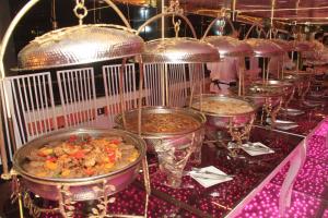 a row of buffetarded dishes of food on a table at نادى يخت الجيزة in Cairo