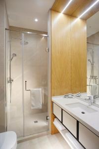 y baño con ducha, lavabo y aseo. en NEOS HOTEL en Astaná
