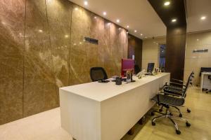 an office with a white desk and chairs in it at The Thane Club in Thane +38 photos