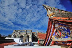 a view of a building and a blue sky with clouds at Feng Mao Lin Zhi in Jincheng