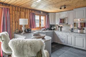 a kitchen with white cabinets and a counter with a sink at Tio Pepe OG in Fiesch