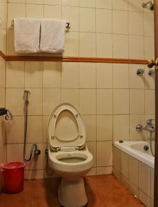 a bathroom with a toilet and a bath tub at Hotel Chautari pvt ltd in Nagarkot