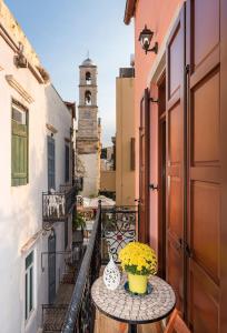 a balcony with a table and vases on it at Palazzo di Irene in Chania