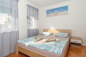 a bedroom with a bed and a window at Apartment Molnar Crikvenica in Crikvenica