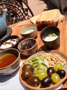 a table with a plate of food and bowls of food at Terra Firma Hotel Boutique in Villa Carlos Paz