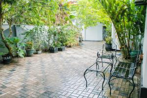 a patio with a bunch of plants and chairs at Villa Harbour View in Galle