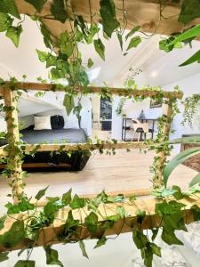 a bedroom with a bed with ivy on the ceiling at Defoy Getaway - Antibes in Antibes