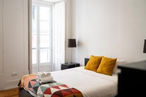 a bedroom with a bed with two towels on it at Santana Apartment in Lisbon