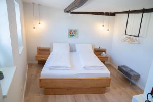 1 dormitorio con 1 cama grande con sábanas blancas en BACCO Bed & Breakfast, en Rotenburg an der Fulda