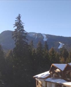 a house with a view of a mountain at Апартамент С-59 в Апарт-хотел Боровец Гардънс in Borovets