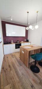 a kitchen with a wooden table and a chair at Willa Matejki in Przemyśl